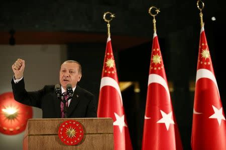 Turkish President Tayyip Erdogan makes a speech during a fast-breaking iftar dinner at the Presidential Palace in Ankara, Turkey, June 20, 2017. Picture taken June 20, 2017. Yasin Bulbul/Presidential Palace/Handout via REUTERS