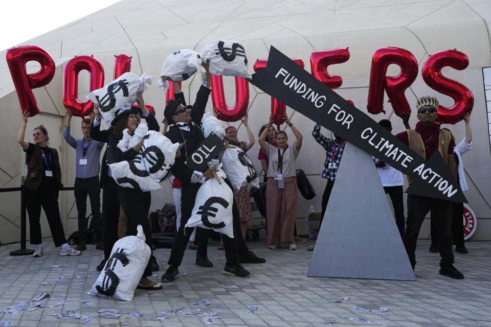 Activists protest against fossil fuels at the COP28 U.N. Climate Summit, Sunday, Dec. 10, 2023, in Dubai, United Arab Emirates. (AP Photo/Rafiq Maqbool)