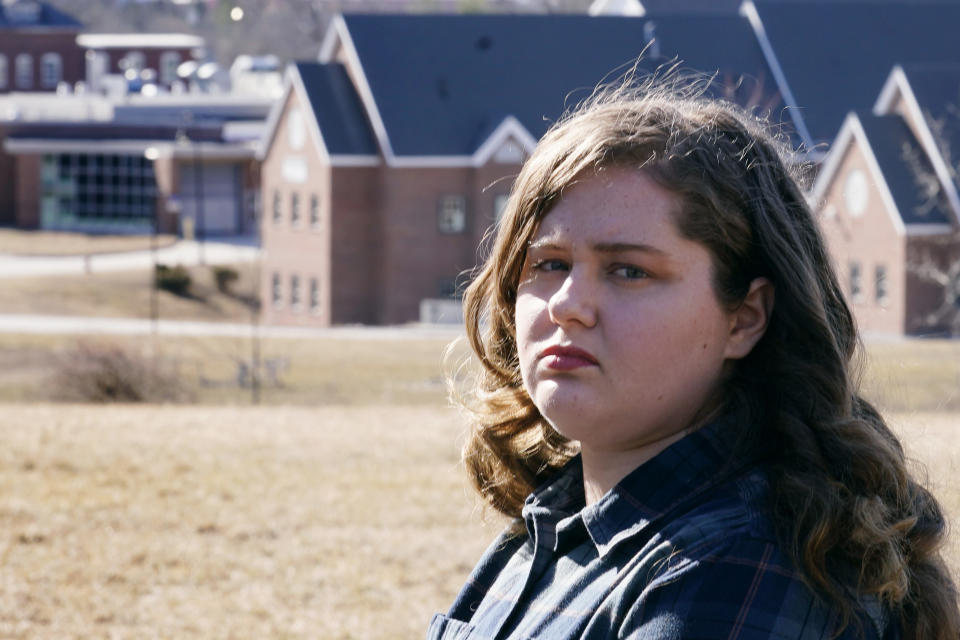 Mary Goddard poses outside the Sununu Youth Development Center, Tuesday, March 23, 2021, in Manchester, N.H. Goddard, a former intern at New Hampshire’s youth detention center says a supervisor suggested she destroy her notes and lie about a teen’s sexual assault allegation. And though she reported the boy’s claim to state investigators and police, it wasn’t included in an annual report that state officials submitted to the federal government.(AP Photo/Charles Krupa)