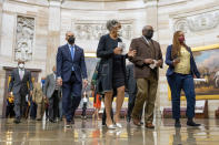 From left, Rep. Hakeem Jeffries, D-N.Y., Rep. Joyce Beatty, D-Ohio, and House Majority Whip Jim Clyburn, D-S.C., and other members of the Congressional Black Caucus, walk to the Senate chamber to speak to reporters about their support of voting rights legislation at the Capitol in Washington, Wednesday, Jan. 19, 2022. (AP Photo/Amanda Andrade-Rhoades)