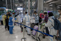 Chinese tourists from Shanghai arrive at Suvarnabhumi airport on special tourist visas, in Bangkok, Thailand, Tuesday, Oct. 20, 2020. Thailand on Tuesday took a modest step toward reviving its coronavirus-battered tourist industry by welcoming 39 visitors who flew in from Shanghai, the first such arrival since normal traveler arrivals were banned almost seven months ago. (AP Photo/Wason Wanichakorn)