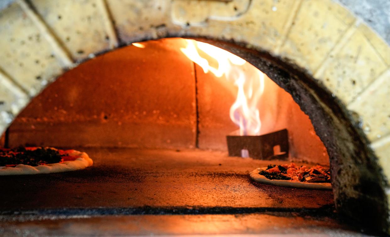 A pizza bakes at Strong's Brick Oven Pizza in Newport.