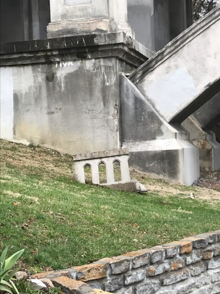 A large piece of the Victory Parkway Bridge embedded into the ground below.