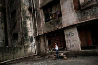 A girl talks with a friend at the abandoned Prestes Maia textile factory occupied by a homeless movement in downtown Sao Paulo, Brazil, May 8, 2018. REUTERS/Nacho Doce