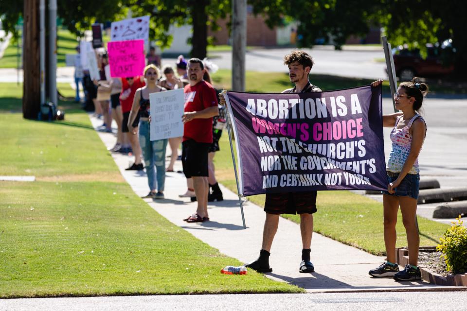 Protesters line the street of Adams Boulevard outside the Bartlesville Community Center Monday to protest the Supreme Court's ruling overturning Roe v. Wade.