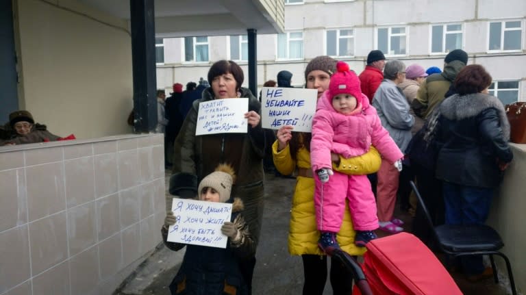 Local residents of Volokolamsk hold placards, one reading "Don't kill our kids!", and gather outside the local hospital on March 21, 2018