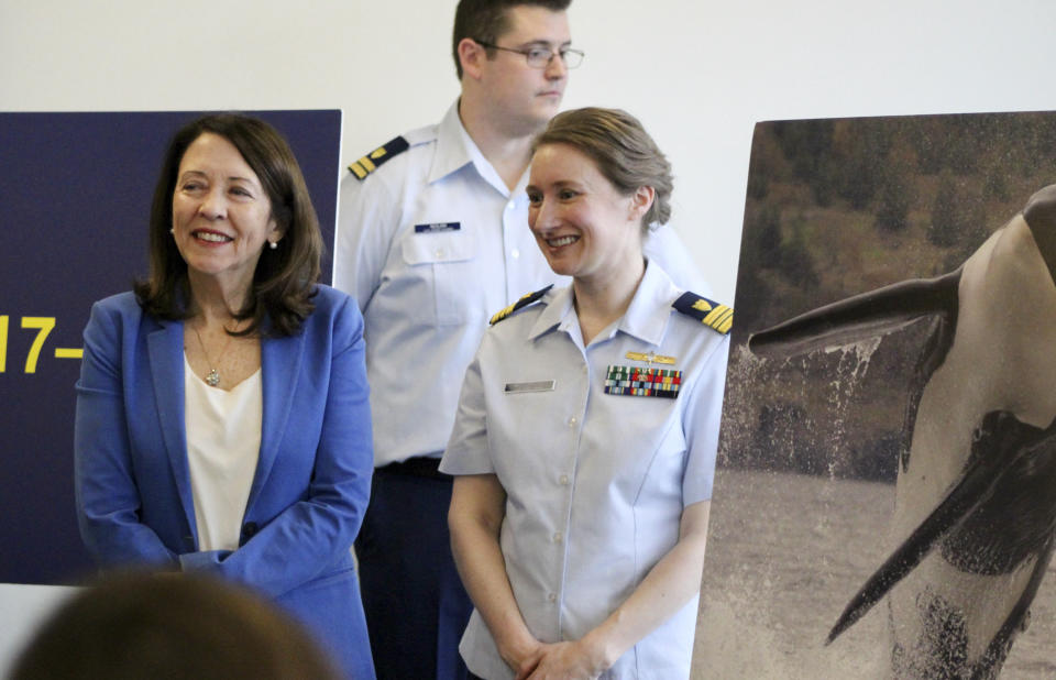 U.S. Sen. Maria Cantwell, D-Wash., left, stands next to Lt. Cmdr. Margaret Woodbridge at a press conference in Seattle, Wednesday, Feb. 21, 2024. The U.S. Coast Guard is launching a whale alert program, which Woodbridge is managing, in Washington's Salish Sea to help commercial and transit ships steer clear of the marine mammals. (AP Photo/Manuel Valdes)