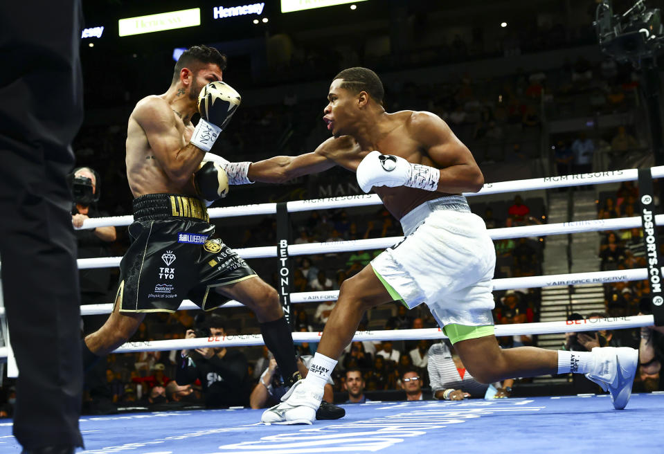 Jorge Linares, left, takes a hit from Devin Haney during the WBC lightweight title boxing match Saturday, May 29, 2021, in Las Vegas. (AP Photo/Chase Stevens)