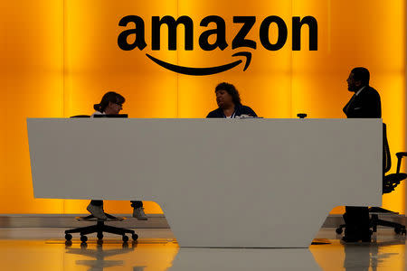 FILE PHOTO: Staff chat at the front desk of the Amazon office in the Manhattan borough of New York, New York, U.S., May 1, 2019. REUTERS/Carlo Allegri/File Photo