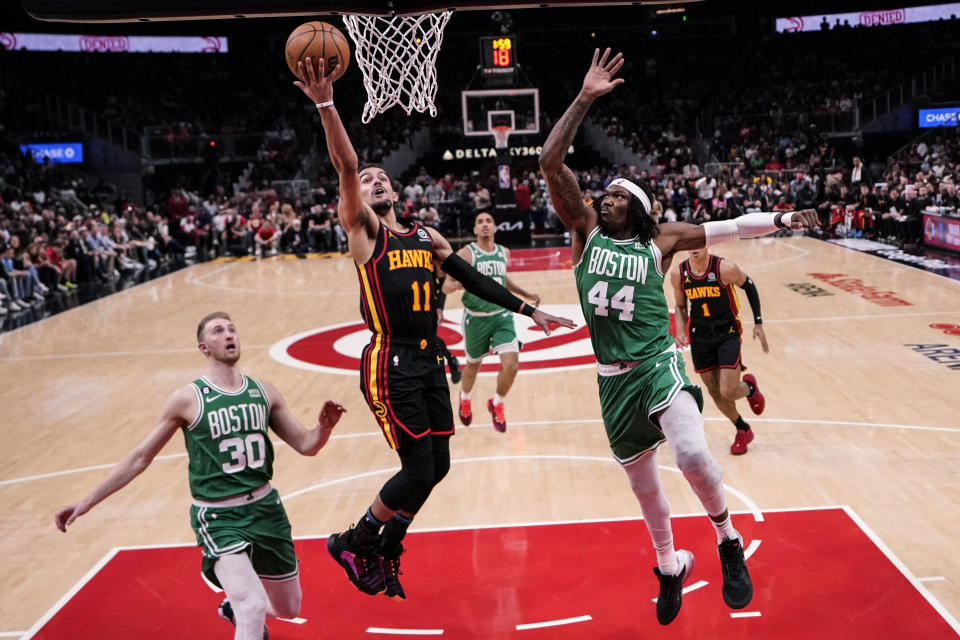 Atlanta Hawks guard Trae Young (11) shoots against Boston Celtics center Robert Williams III (44) during the second half of Game 3 of a first-round NBA basketball playoff series, Friday, April 21, 2023, in Atlanta. (AP Photo/Brynn Anderson)