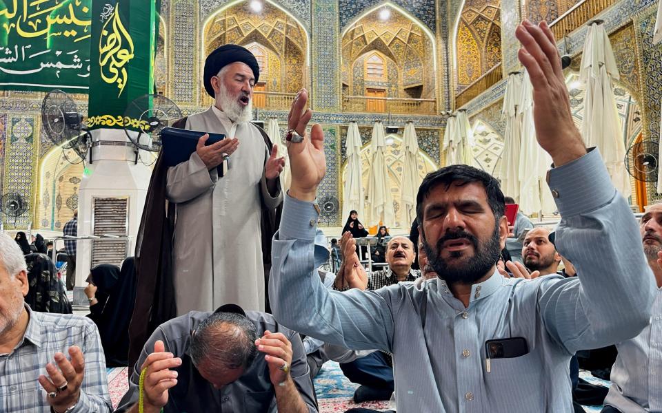 Iranian Shi'ite pilgrims pray for Raisi at the Imam Ali shrine in the holy city of Najaf in Iraq on Sunday.