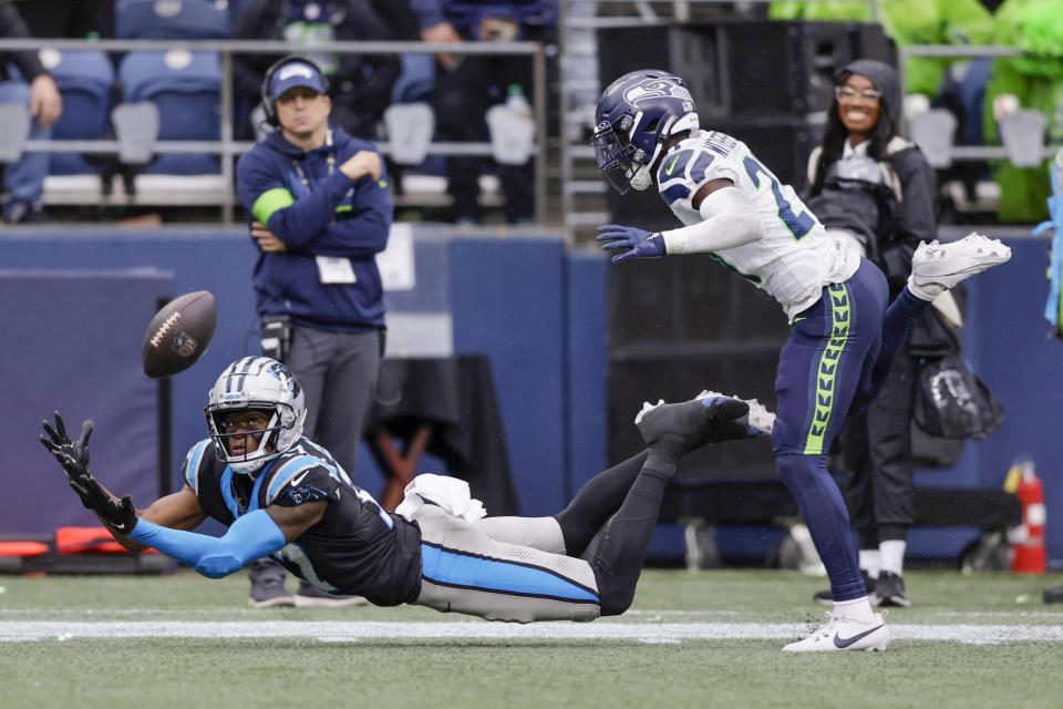 Seattle Seahawks cornerback Devon Witherspoon, right, breaks up a pass intended for Carolina Panthers wide receiver DJ Chark Jr. during the second half of an NFL football game Sunday, Sept. 24, 2023, in Seattle. (AP Photo/John Froschauer)