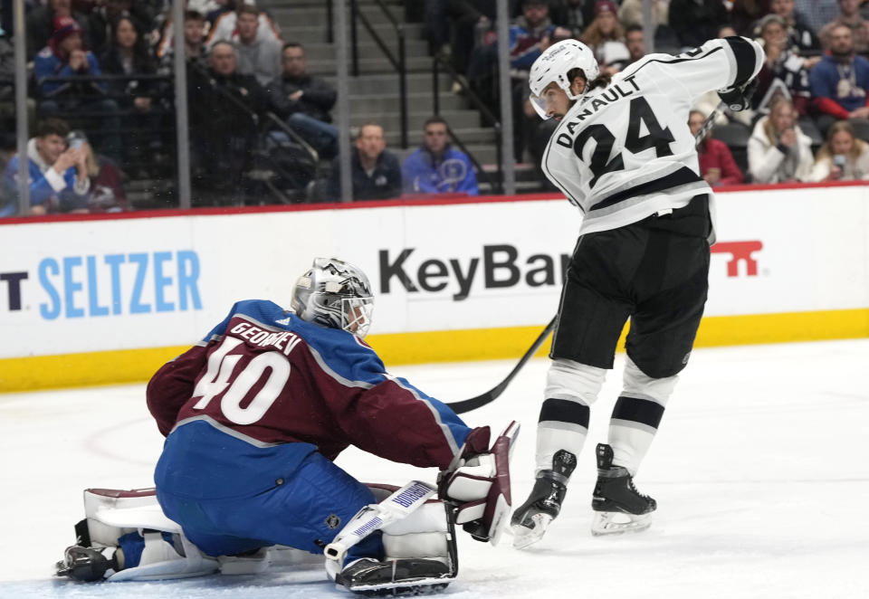 Los Angeles Kings center Phillip Danault, right, redirects the puck at Colorado Avalanche goaltender Alexandar Georgiev in the second period of an NHL hockey game Thursday, March 9, 2023, in Denver. (AP Photo/David Zalubowski)
