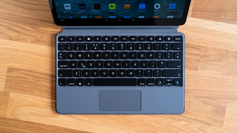 Close up of Amazon Fire Max 11 tablet keyboard on a wooden surface