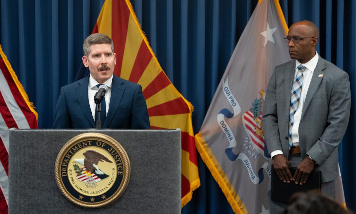 <span>The head of the justice department's election threats taskforce, John D Keller, speaks as FBI Phoenix field office special agent in charge, Akil Davis, listens during a press conference on Monday in Phoenix, Arizona.</span><span>Photograph: Rebecca Noble/Getty Images</span>