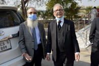 Mehmood A. Sheikh, right, defense lawyer, and Ahmed Saeed Sheikh, father of British-born Pakistani Ahmed Omar Saeed Sheikh, leave the Supreme Court after an appeal hearing in the Daniel Pearl case in Islamabad, Pakistan, Thursday, Jan. 28, 2021. The court on Thursday has ordered the release of Sheikh convicted and later acquitted in the gruesome beheading of American journalist Daniel Pearl in 2002. The court also dismissed an appeal of Sheikh's acquittal by Pearl's family. (AP Photo/Waseem Khan)