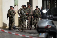 <p>French soldiers gather at the site where a car slammed into soldiers on patrol in Levallois-Perret, outside Paris, on August 9, 2017. (Photo: Stephane de Sakutin/AFP/Getty Images) </p>