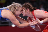 <p>Russia's Liubov Ovcharova (red) wrestles Sweden's Henna Katarina Johansson in their women's freestyle 62kg wrestling repechage match during the Tokyo 2020 Olympic Games at the Makuhari Messe in Tokyo on August 4, 2021. (Photo by Jack GUEZ / AFP)</p> 