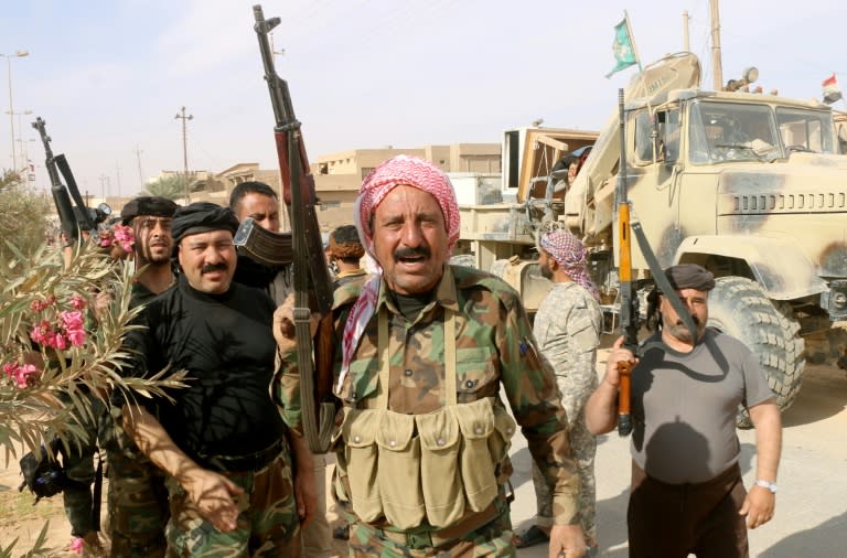 Iraqi pro-government forces gather in Rawa on November 18, 2017, after troops retook the Euphrates valley town from Islamic State group jihadists