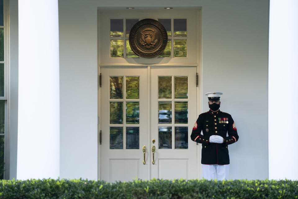 In this Oct. 8, 2020 photo, a Marine is posted outside the West Wing of the White House, signifying the President is in the Oval Office, in Washington. Courts nationwide have seen a flurry of litigation over the 2020 presidential election as both major parties jockey for every advantage. President Donald Trump and Democrat Joe Biden’s campaigns are assembling armies of powerful lawyers. (AP Photo/Evan Vucci)