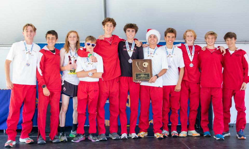 The Foothill Tech boys team poses with its Division IV third-place plaque at the CIF State Cross Country Championships on Saturday, Nov. 25, 2023, at Woodward Park in Fresno.