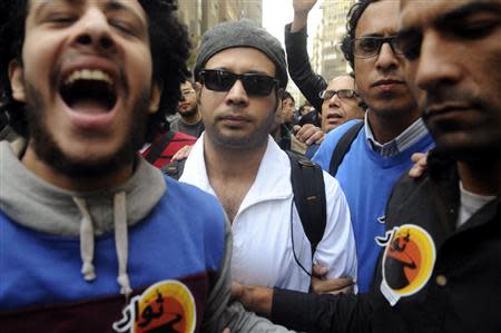 Ahmed Maher (C), founder of the April 6 movement, turns himself in at Abdeen court in Cairo November 30, 2013. REUTERS/Stringer