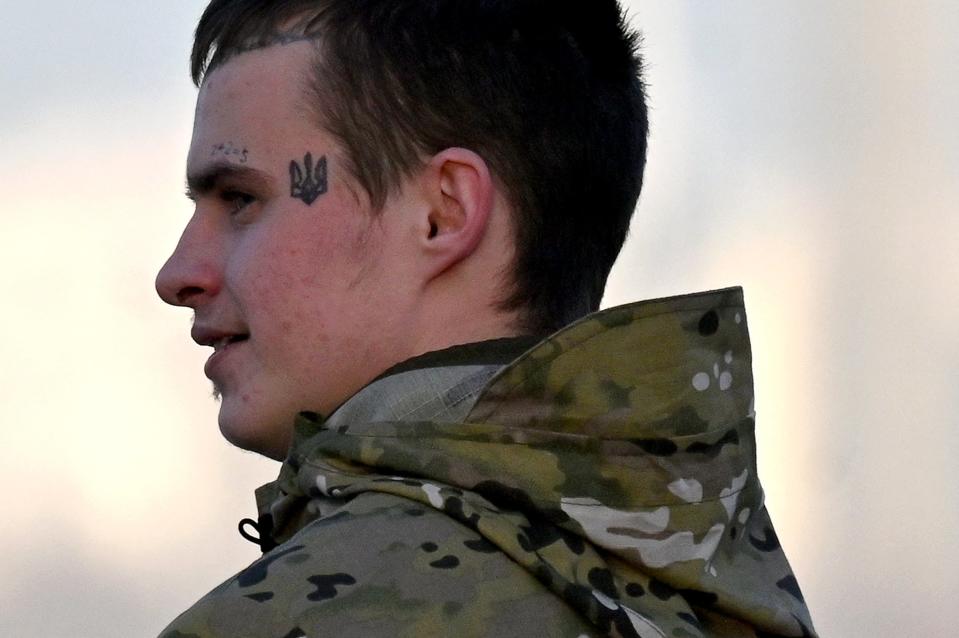 A young Ukrainian serviceman, wearing a tattoo depicting the Ukrainian state coat of arms, walks in the center of the capital Kyiv (AFP via Getty Images)