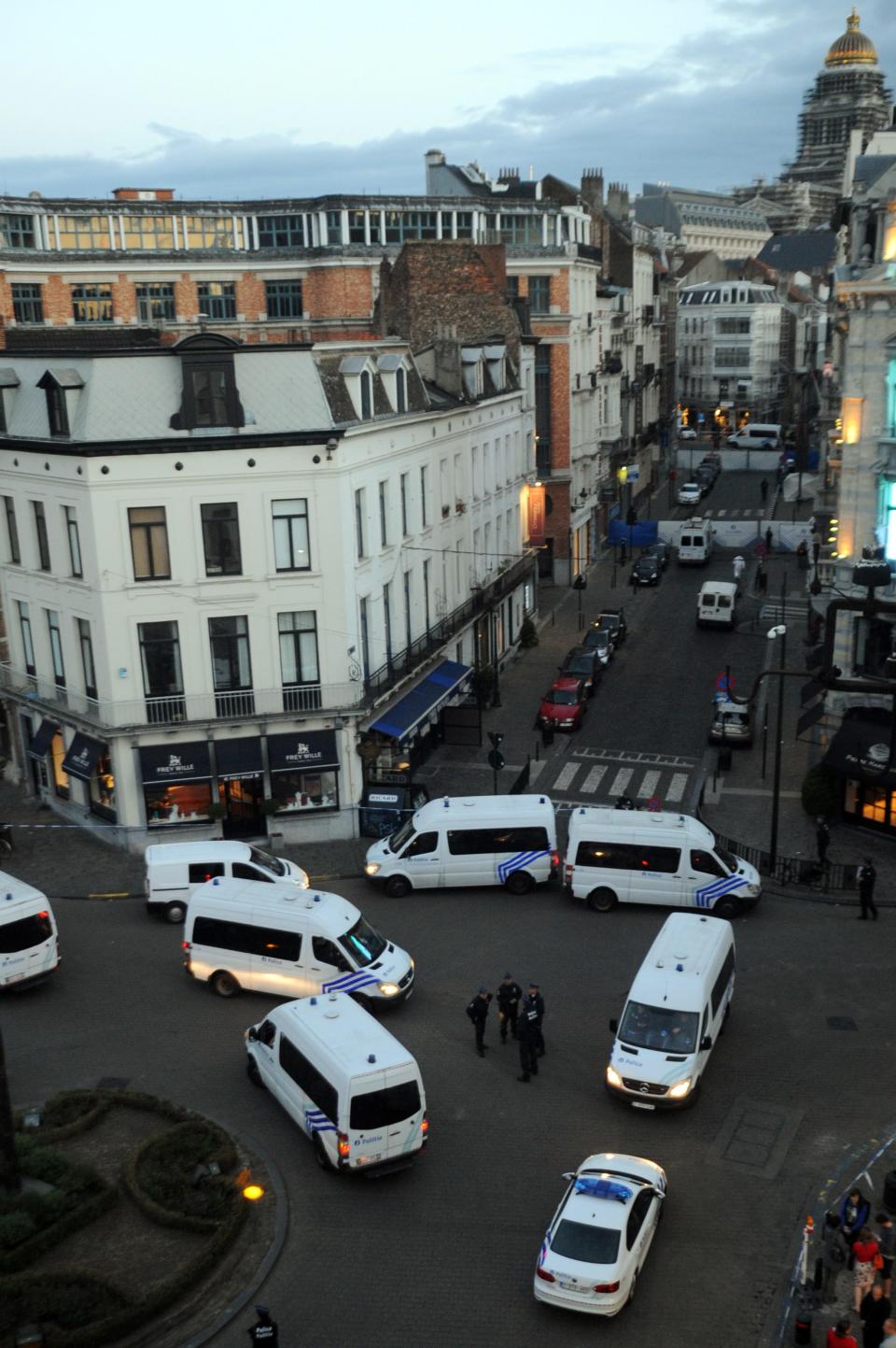 Police personnel are seen at the site of a shooting in Brussels