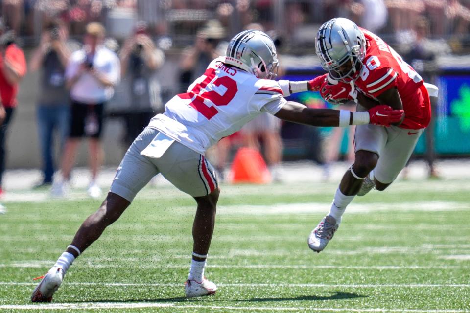 Apr 15, 2023; Columbus, Ohio, United States;  Ohio State Buckeyes wide receiver Noah Rogers (80) dodges Ohio State Buckeyes safety Brenten Jones (32) during the fourth quarter of the Ohio State Buckeyes spring game at Ohio Stadium on Saturday morning. Mandatory Credit: Joseph Scheller-The Columbus Dispatch