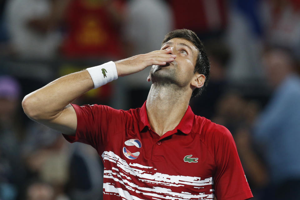 Novak Djovovic of Serbia reacts after winning the match against Rafael Nadal of Spain during their ATP Cup tennis match in Sydney, Sunday, Jan. 12, 2020. (AP Photo/Steve Christo)