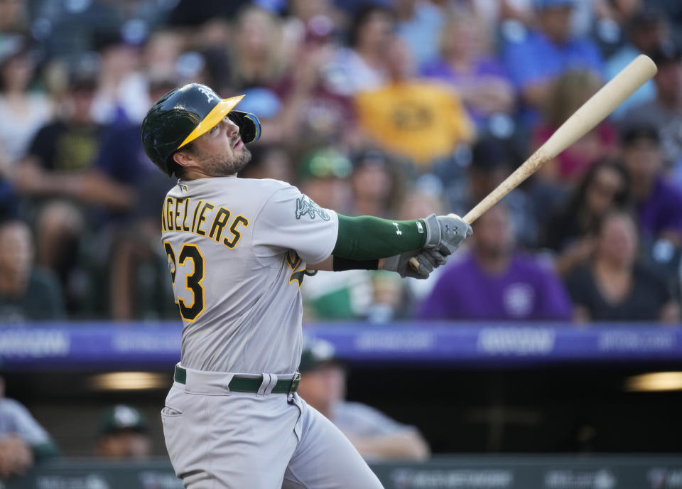 Oakland Athletics' Shea Langeliers watches his RBI triple off Colorado Rockies starting pitcher Kyle Freeland during the second inning of a baseball game Friday, July 28, 2023, in Denver. (AP Photo/David Zalubowski)