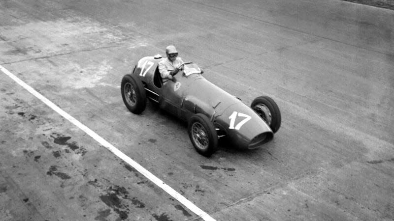 A black and white photo of a Ferrari 500 race car taken in 1952