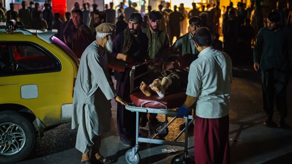 A wounded patient is brought by taxi to the hospital in Kabul on the day of the attack. - Marcus Yam/Los Angeles Times/Getty Images