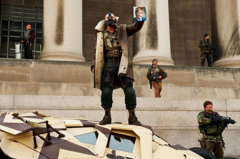 Tom Hardy, center, as Bane, is shown in a scene in Warner Bros. Pictures’ and Legendary Pictures’ action thriller “The Dark Knight Rises,” a Warner Bros. Pictures release. TM & © DC Comics. (AP Photo/Warner Bros. Pictures, Ron Phillips)