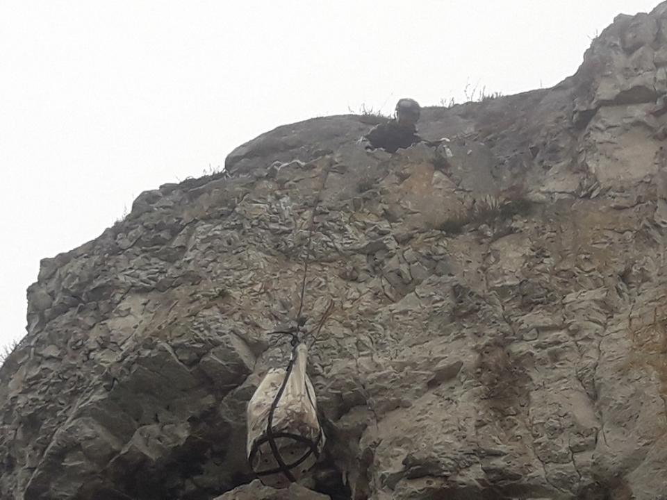 The sheep was put in a bag before being hauled up the cliff edge (National Trust/PA)