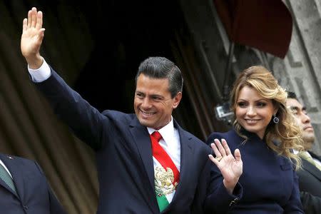 Mexico's President Enrique Pena Nieto and first lady Angelica Rivera wave during the military parade celebrating Independence Day at the Zocalo square in downtown Mexico City in this September 16, 2014 file photo. REUTERS/Edgard Garrido/Files