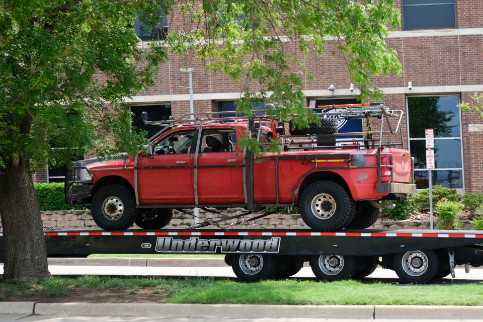 A red pickup is delivered May 13 outside of Prairie Surf Studios along Reno Avenue as crews work on filming the upcoming movie "Twisters."