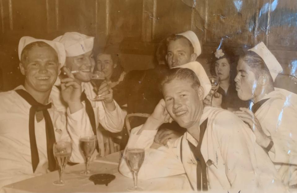 Charles Harlock, center, of Wabasso, Florida, sits with buddies in this undated picture from World War II.