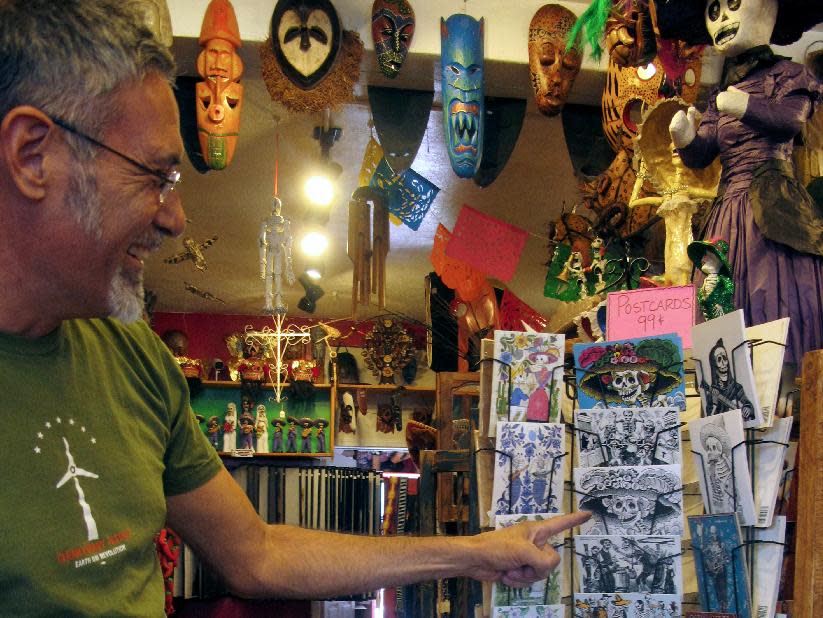 In this May 8, 2013 photo, artwork is shown at Masks y Mas, an Albuquerque shop that sells 'Day of the Dead' art year round. Disney announced Tuesday that it was a withdrawing a "Dia de los Muertos" trademark request it made to the U.S. Patent and Trademark Office amid uproar on social media from Latino activists, writer and artists. Disney had sought to secure naming right for an upcoming animated movie inspired by the holiday. Critics said the move to trademark a cultural holiday was insensitive. (AP Photo/Russell Contreras)
