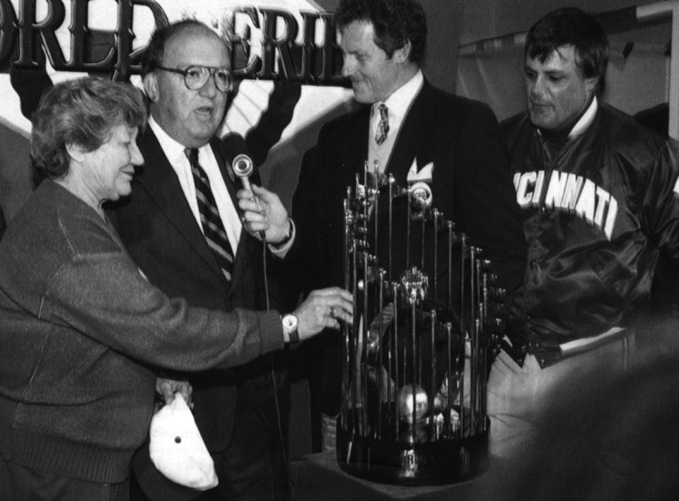 OCTOBER 20, 1990: Cincinnati Reds owner Marge Schott reaches for the world Series trophy Saturday, 10/20/90, night after the Reds swept the A's at Oakland in four straight. Baseball commissioner Fay Vincent talks with announcer as Reds manager Lou Piniella looks on at right.