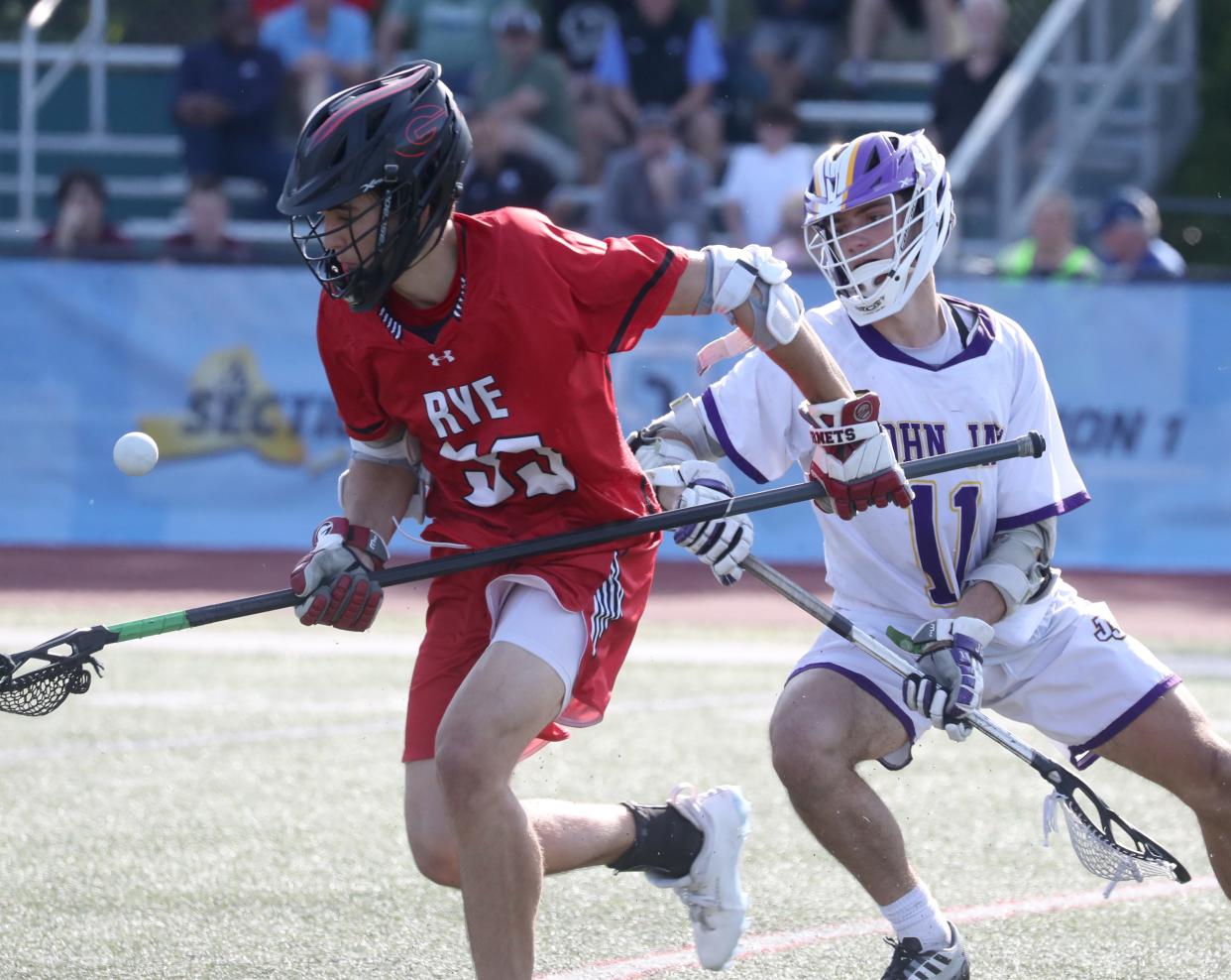 Rye's Chris Iuliano is pressured by John Jay's Andrew Kiefer during the Class C final played at Yorktown May 26, 2023. Rye won 7-4.