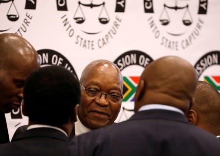 Former South African President Jacob Zuma talks with members of his legal team during a break in proceedings at the Commission of Inquiry into State Capture in Johannesburg