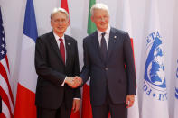 French Finance Minister Bruno Le Maire, right, welcomes British Chancellor of the Exchequer Philip Hammond at the G-7 Finance Wednesday July 17, 2019.The top finance officials of the Group of Seven rich democracies are arriving at Chantilly, at the start of a two-day meeting aimed at finding common ground on how to tax technology companies and on the risk from new digital currencies. (AP Photo/Michel Euler)