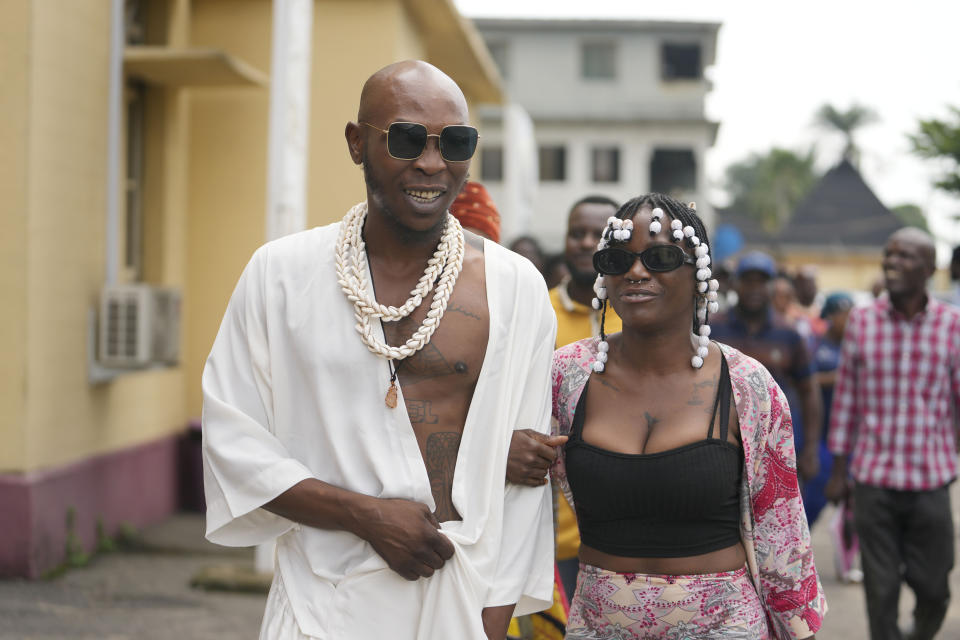 Afrobeat star, Seun Kuti, left, and his wife Yetunde Kuti, walk out of the Magistrate court room after he was granted bail by a judge in Lagos, Nigeria, Wednesday, May 24, 2023. Kuti who is facing trial on charges of assaulting a police officer will embark on a delayed concert tour after being released on bail, his manager said Wednesday. (AP Photo/Sunday Alamba)