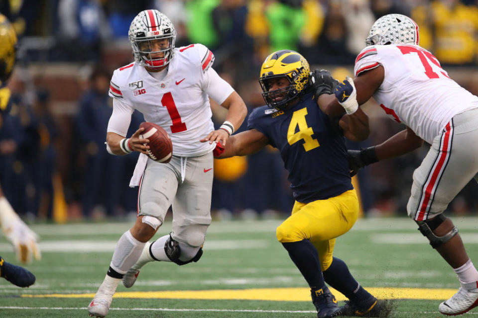 Justin Fields of the Ohio State Buckeyes and Michael Danna of the Michigan Wolverines on November 30, 2019, in Ann Arbor. / Credit: Gregory Shamus/Getty