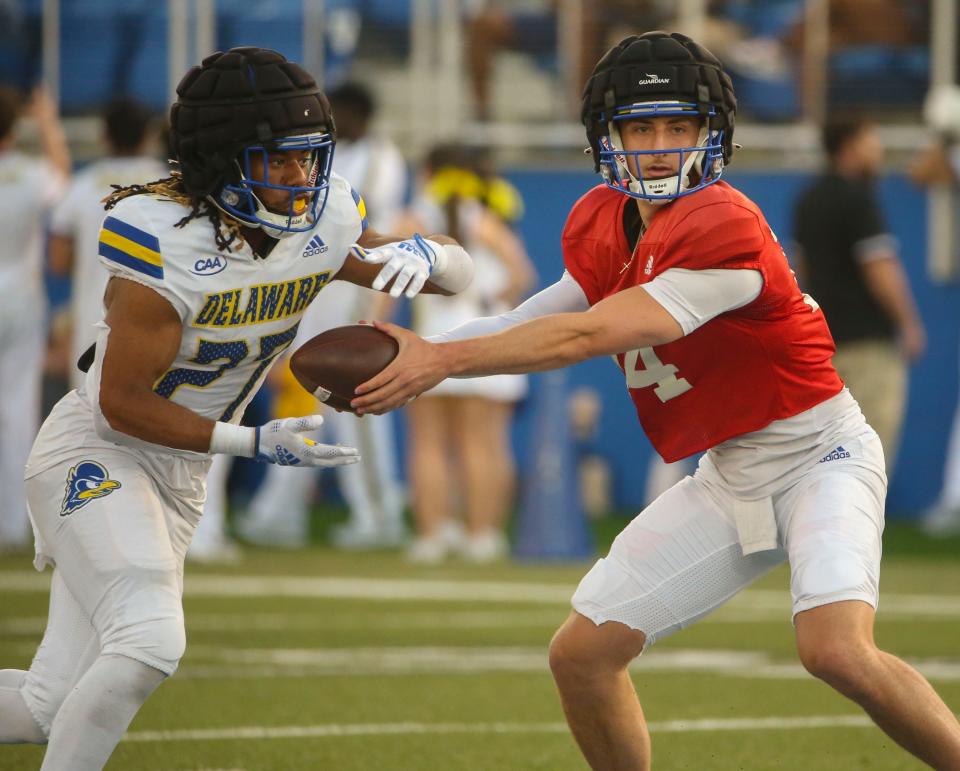 Delaware running back Jo'Nathan Silver takes the ball from Ryan O'Connor during the Blue and White Spring Game capping spring drills, Friday, April 21, 2023 at Delaware Stadium.