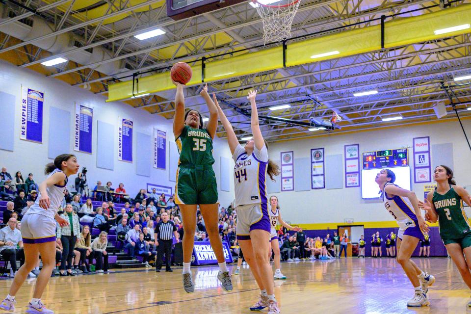 Rock Bridge's Jayda Porter (35) shoots over the arms of Hickman's Addie Schultz (44) during the Bruins' 54-52 win over the Kewpies on January 26, 2023, in Columbia, Mo.