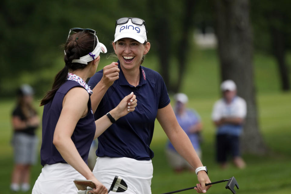 Elizabeth Szokol, right, fist bumps her team partner Cheyenne Knight after a birdie on the 12th green during the final round of the Dow Great Lakes Bay Invitational golf tournament at Midland Country Club, Saturday, July 22, 2023, in Midland, Mich. (AP Photo/Carlos Osorio)