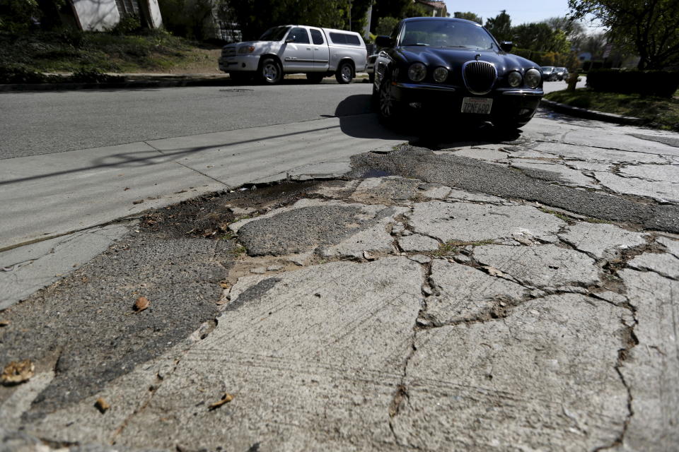 A pothole is pictured on the street of Los Angeles, California February 12, 2016. Nearly two-thirds of Americans would support roadway user fees to help fix the country's crumbling transportation infrastructure, according to a survey to be published on April 28, 2016 that was seen by Reuters.      REUTERS/Mario Anzuoni/File Photo