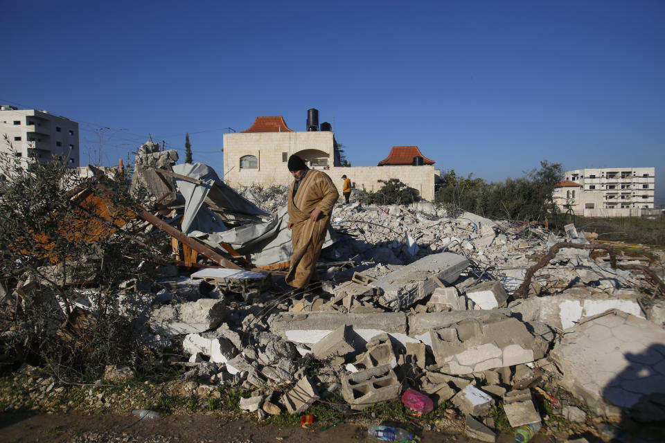 Palestinians inspect a house after it was demolished by the Israeli army in the West Bank city of Jenin, Thursday, Feb. 6, 2020. Israeli military spokesman Lt. Col. Jonathan Conricus said troops were carrying out the demolition of a home belonging to a militant allegedly involved in a deadly attack. (AP Photo/Majdi Mohammed)